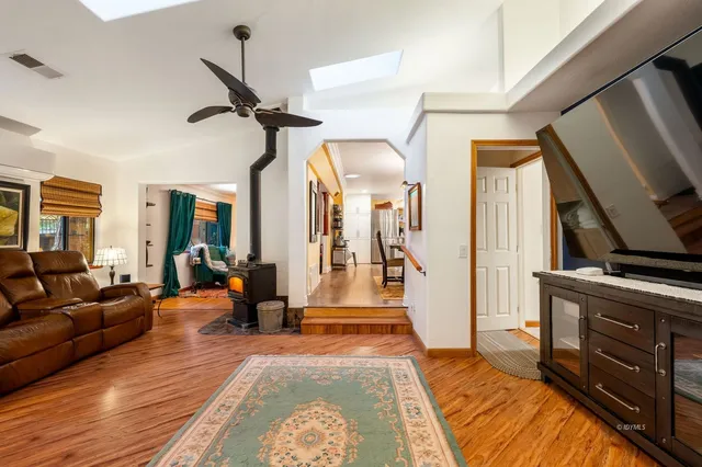 a large white kitchen with a large island in the center