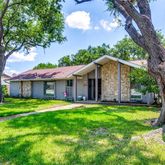 a yellow house in middle of the forest