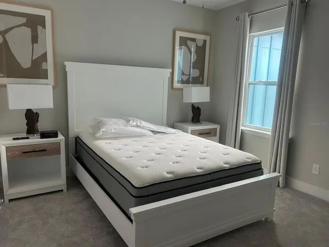 a bedroom with a bed and a chandelier