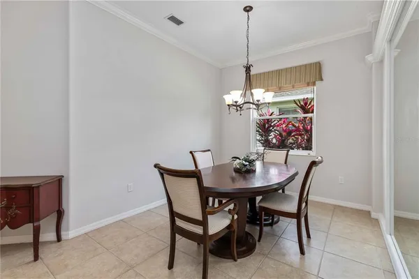a kitchen with stainless steel appliances granite countertop a sink a refrigerator and a granite counter tops with white cabinets