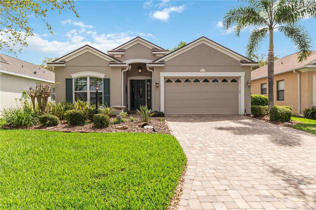 8150 Indigo Ridge Terrace University Park, FL 34201 - Photo 2 of 56 a front view of a house with a yard and potted plants