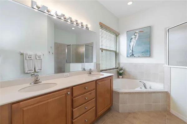 a bedroom with a bed and a flat tv screen on dresser