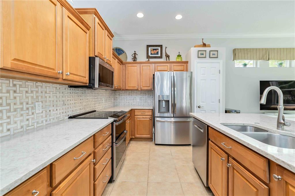 8150 Indigo Ridge Terrace University Park, FL 34201 - Photo 3 of 56 a kitchen with stainless steel appliances granite countertop a sink stove and refrigerator