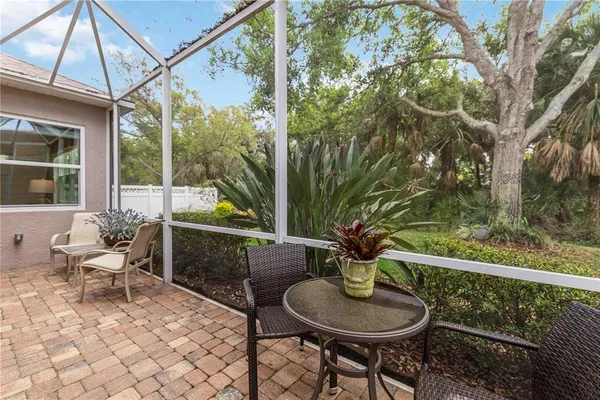 a dining hall with stainless steel appliances granite countertop a sink and dishwasher with wooden floor