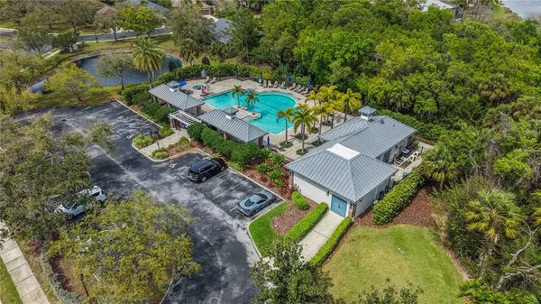 an aerial view of a house with a swimming pool patio and outdoor seating