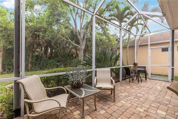 a bedroom with furniture and a large window