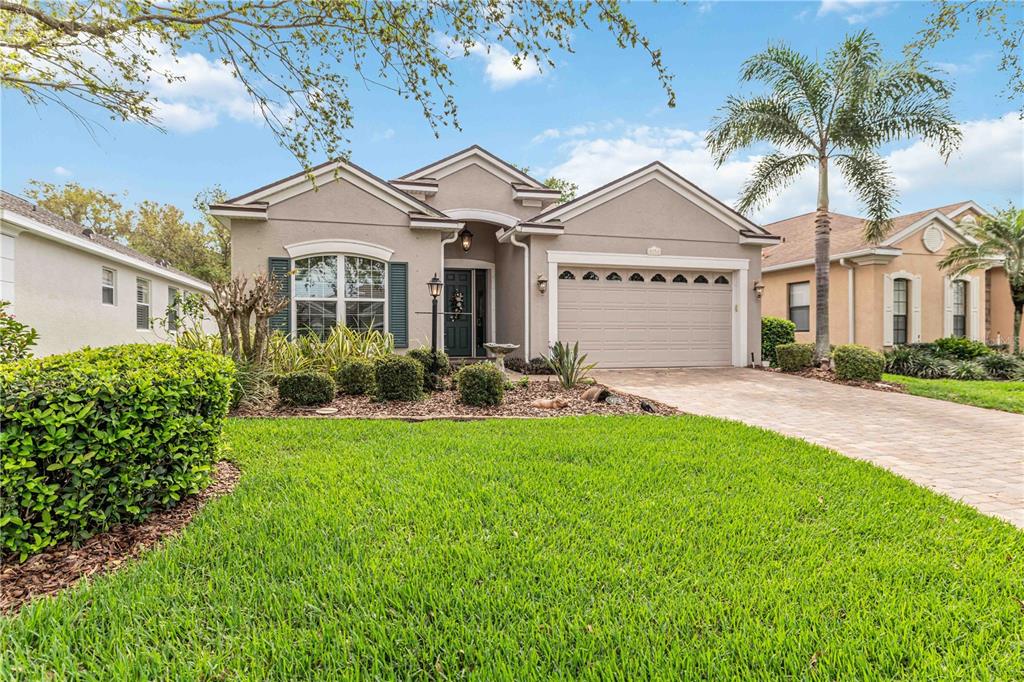 8150 Indigo Ridge Terrace University Park, FL 34201 - Photo 10 of 56 a front view of a house with a garden and plants
