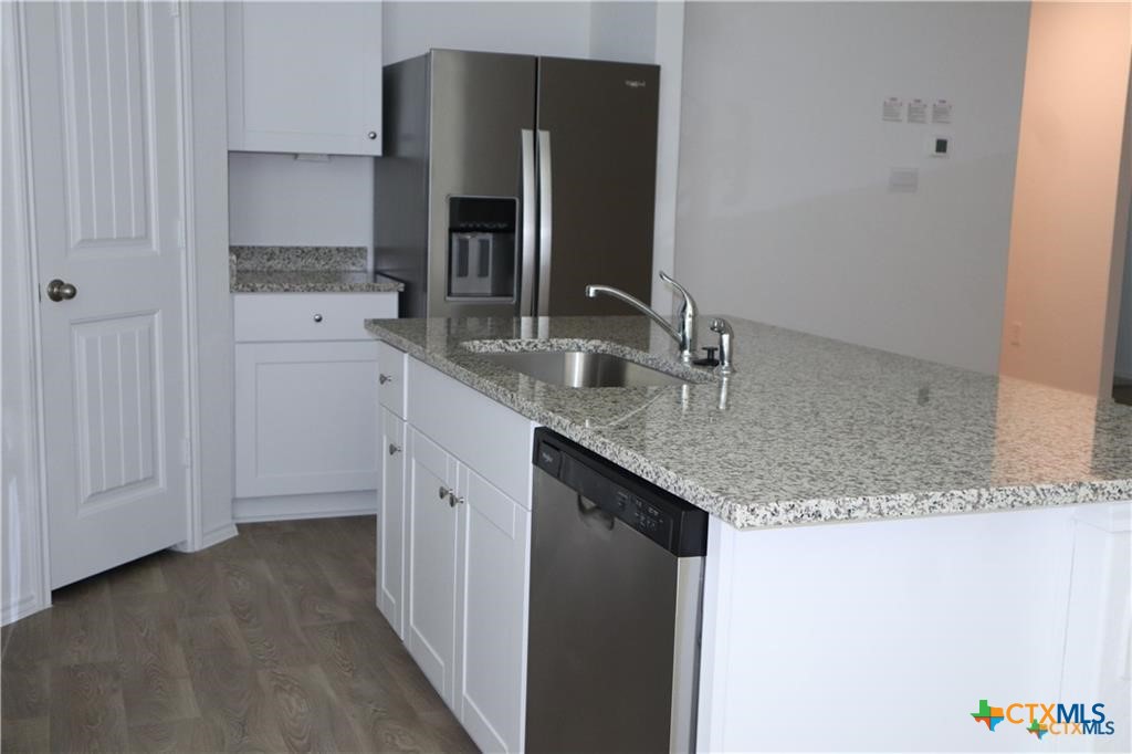 1056 Chachalaca Court Seguin, TX 78155 - Photo 4 of 18 a bathroom with a granite countertop sink and a mirror