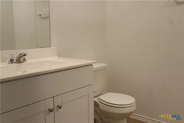 a bathroom with a sink a toilet and a mirror