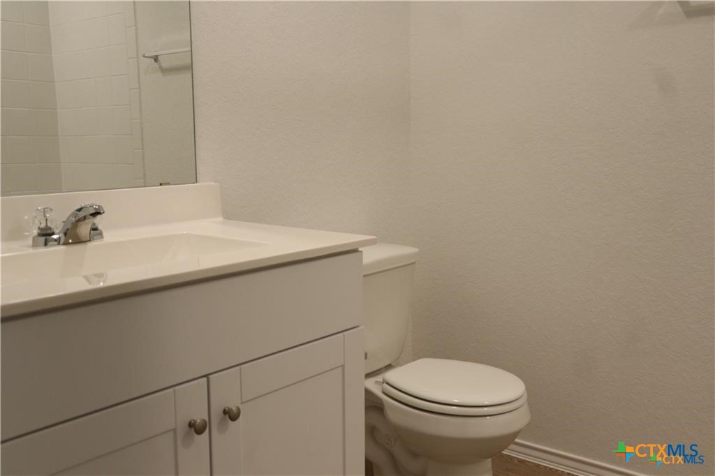 1056 Chachalaca Court Seguin, TX 78155 - Photo 9 of 18 a bathroom with a sink a toilet and a mirror