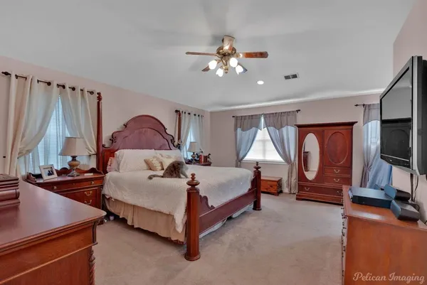 a bedroom with a bed and a chandelier