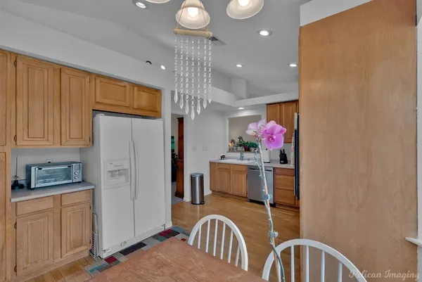 a kitchen with stainless steel appliances granite countertop a refrigerator and a stove top oven