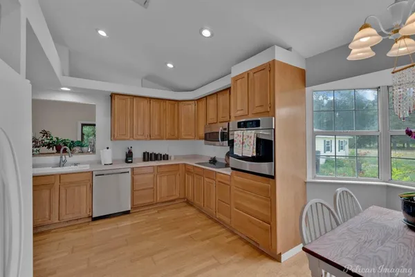a kitchen with cabinets a sink and appliances