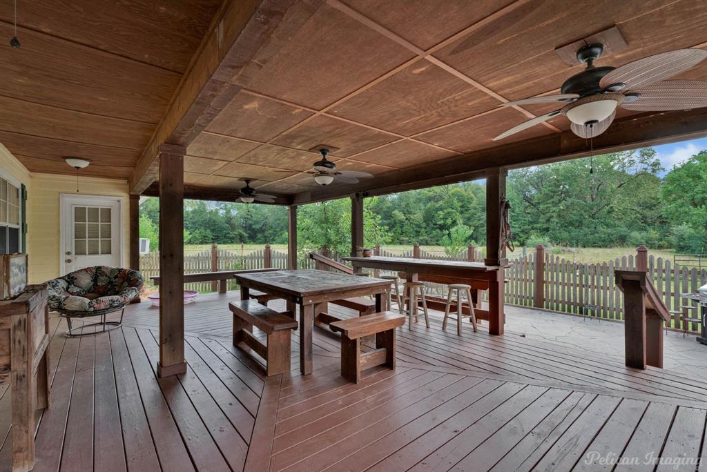 5905 Highway 175 Frierson, LA 71027 - Photo 21 of 29 a view of a patio with table and chairs floor to ceiling window with wooden floor