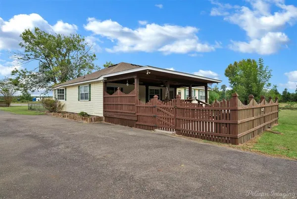 a view of a house with wooden fence