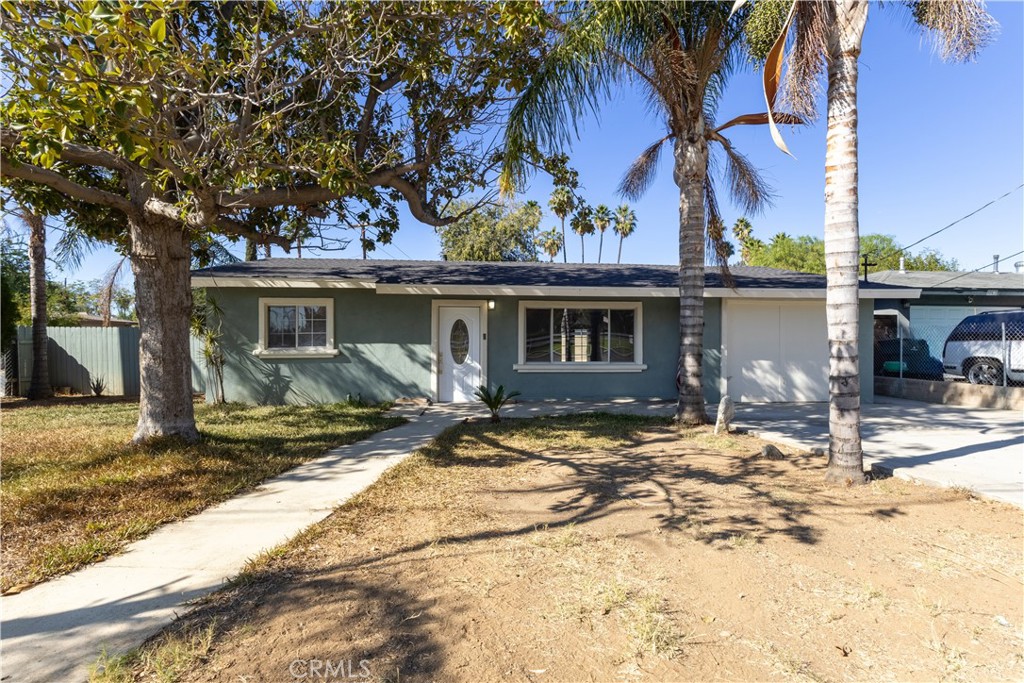 a view of a house with a tree in front of it