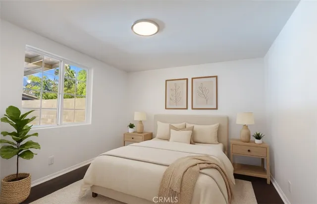 a bedroom with a bed and a potted plant