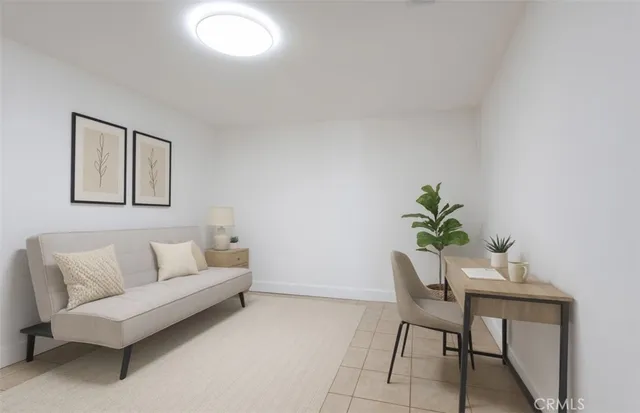 a living room with furniture and a potted plant