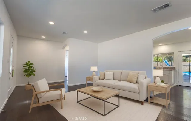 a living room with furniture and a potted plant