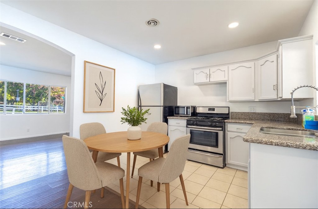 10495 Cook Riverside, CA 92505 - Photo 5 of 19 a kitchen with a dining table chairs and refrigerator