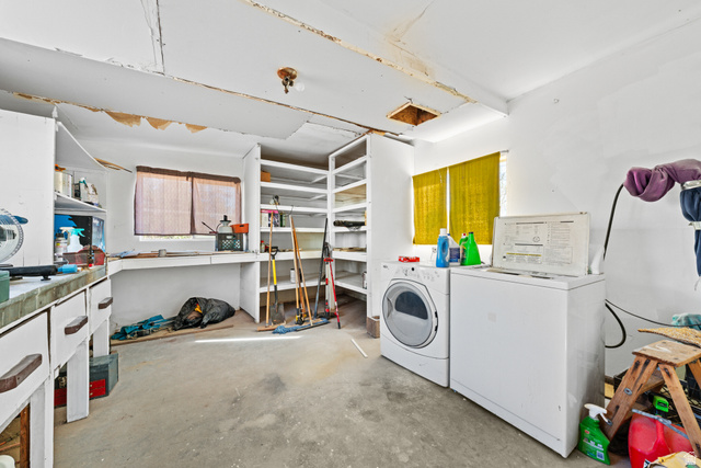49 600 North Hurricane, UT 84737 - Photo 18 of 33 Laundry area featuring concrete flooring, washing machine and dryer, and a workshop area
