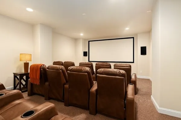 a media room with lots of chairs and a projector screen