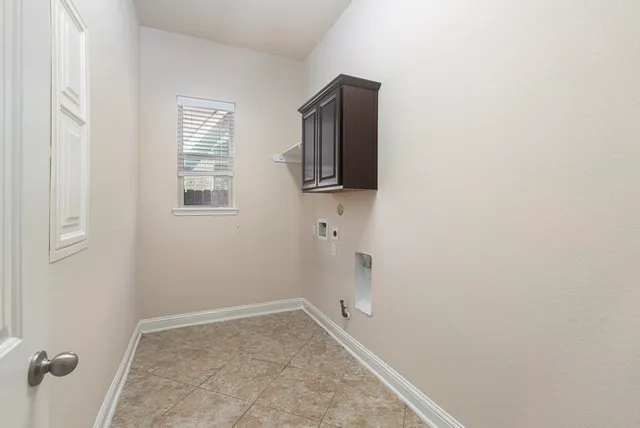 a view of storage and utility room with a fireplace