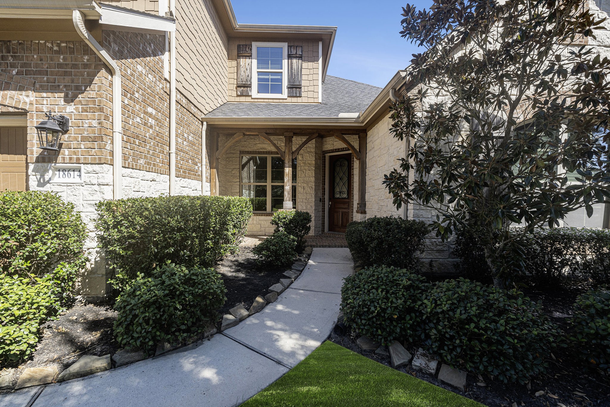 18614 Rimini Ridge Court Cypress, TX 77429 - Photo 3 of 35 a view of a brick house with a yard and plants