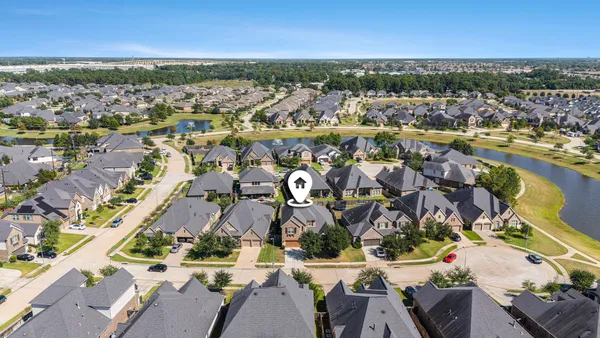 an aerial view of residential building and lake