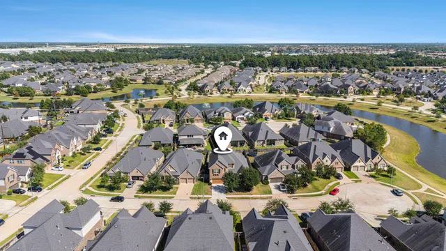 an aerial view of residential building and lake