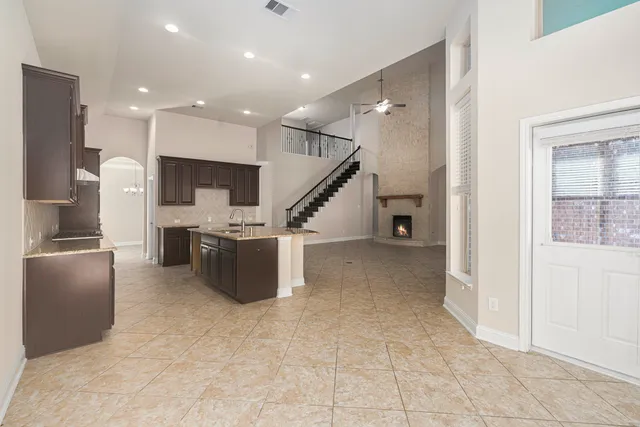 a view of kitchen with furniture and refrigerator