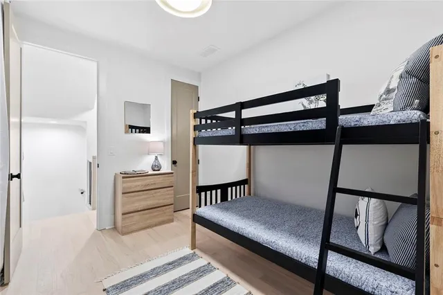 a bedroom with a bed couch and a large window