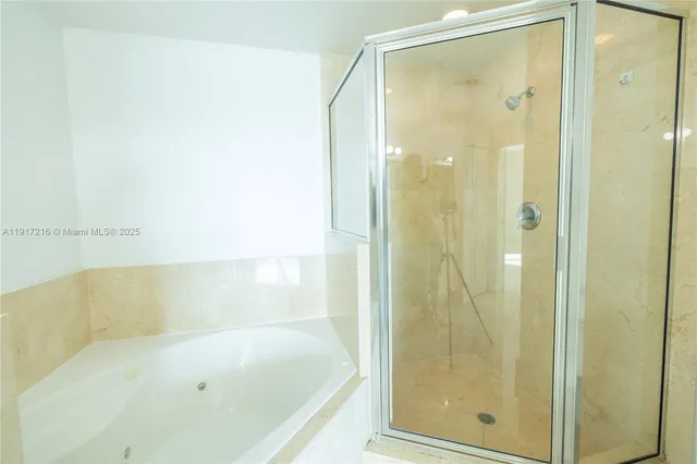 a bathroom with a bathtub and shower