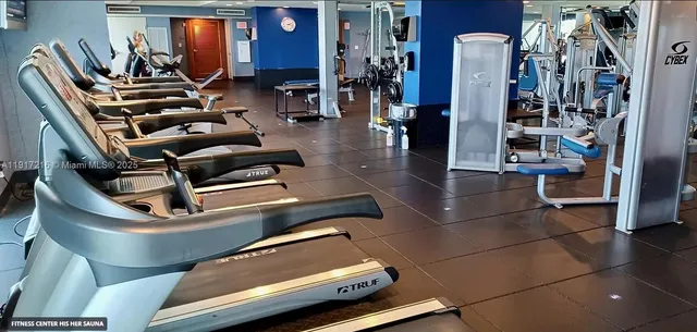 a front view of multi story residential apartment building with yard and sign board