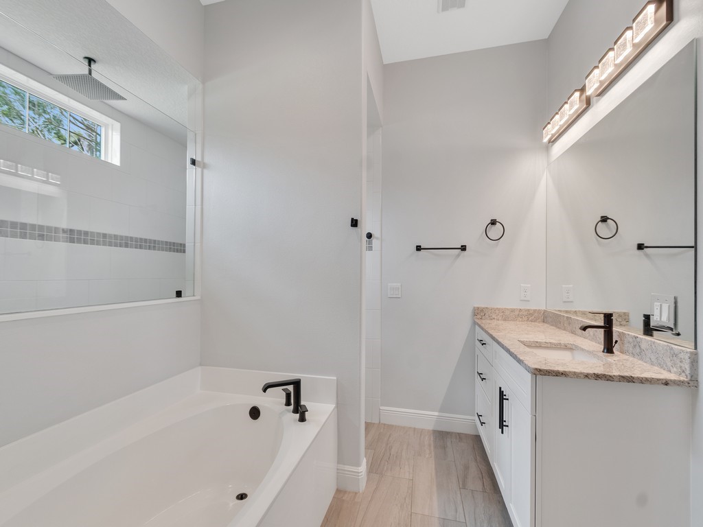 431 Midvale Terrace Sebastian, FL 32958 - Photo 20 of 34 a bathroom with a tub sink and mirror