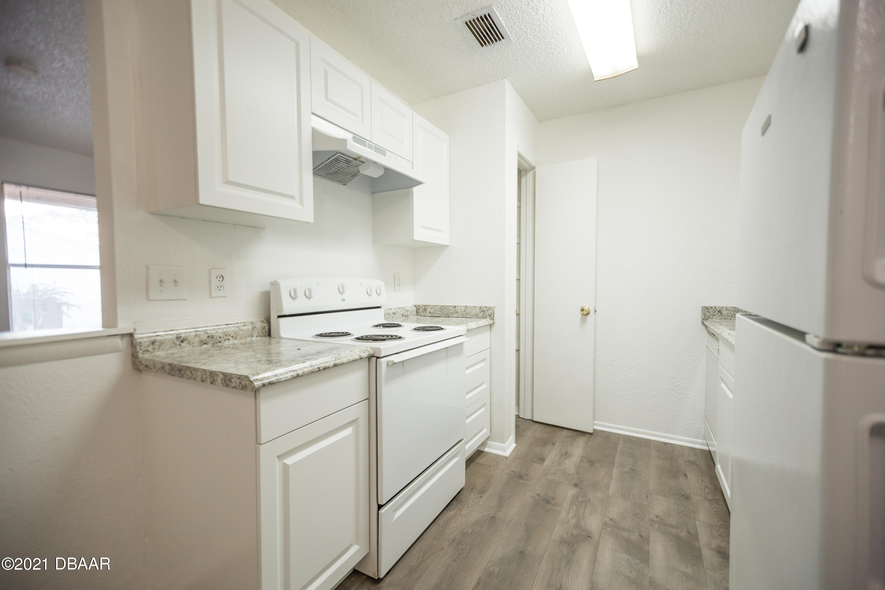 1600 Big Tree Road, Unit B8 South Daytona, FL 32119 - Photo 12 of 27 a kitchen with a sink and cabinets