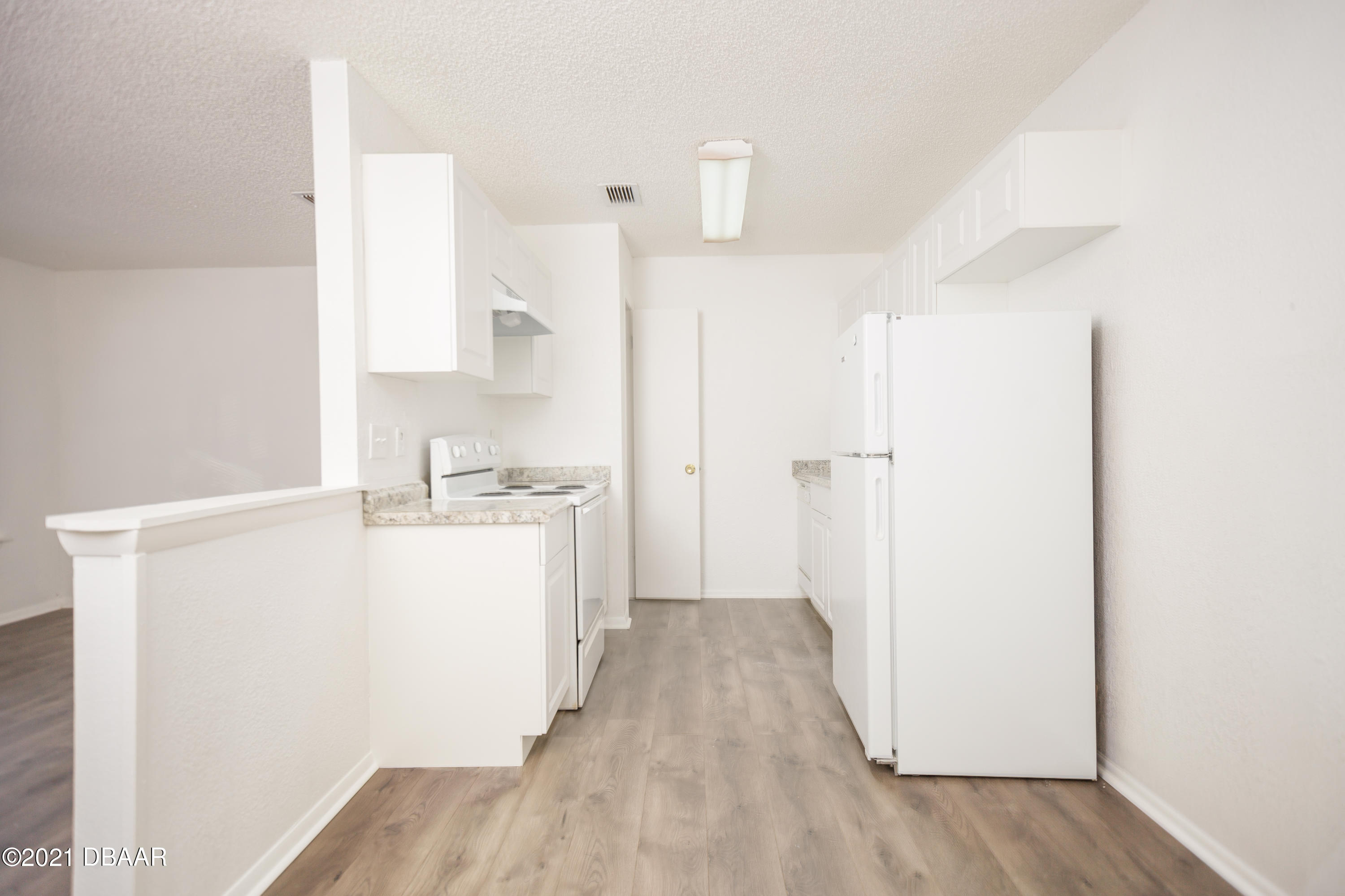 1600 Big Tree Road, Unit B8 South Daytona, FL 32119 - Photo 14 of 27 a view of a kitchen with wooden floor