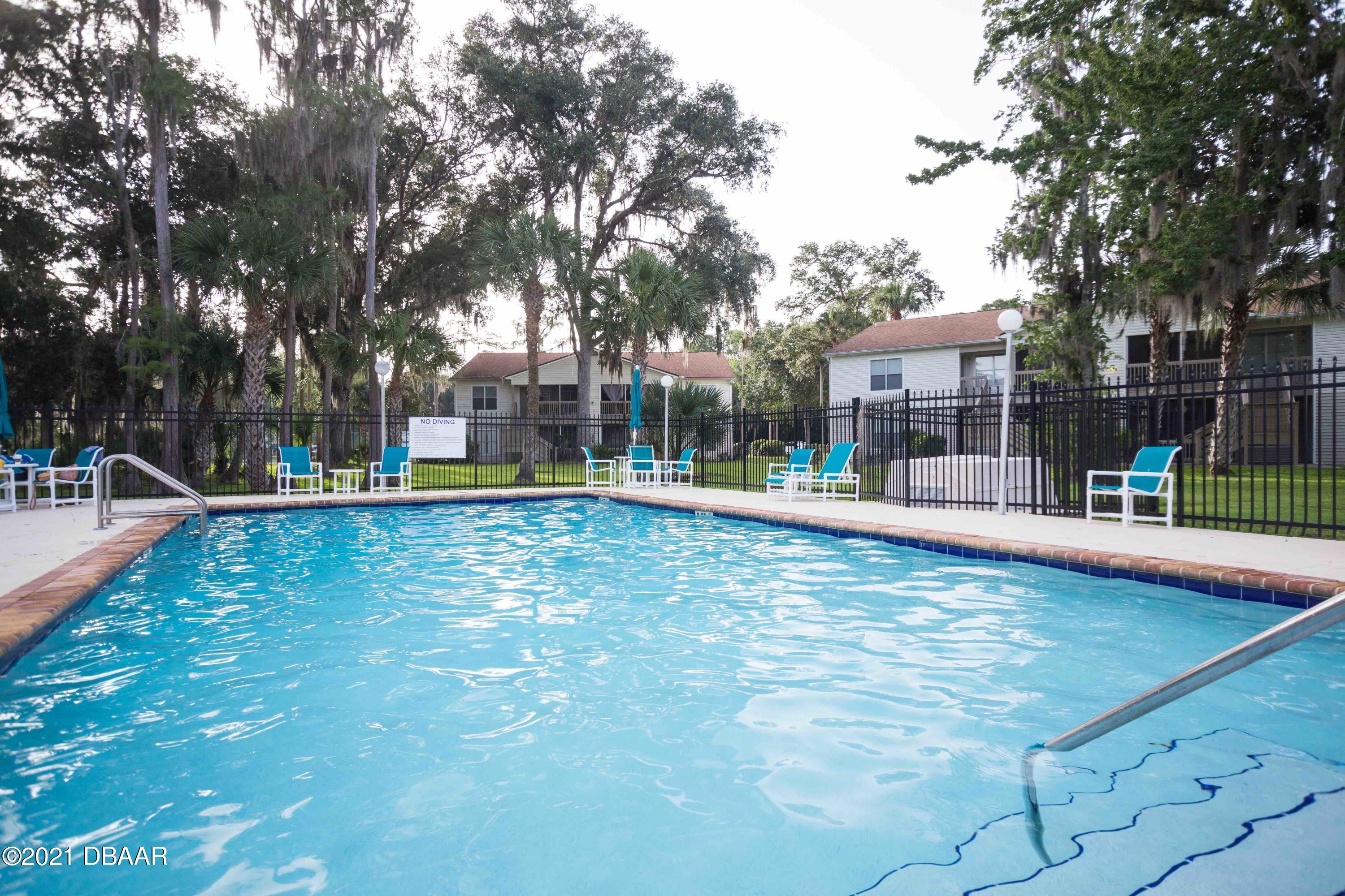 1600 Big Tree Road, Unit B8 South Daytona, FL 32119 - Photo 6 of 27 a view of a swimming pool with a patio
