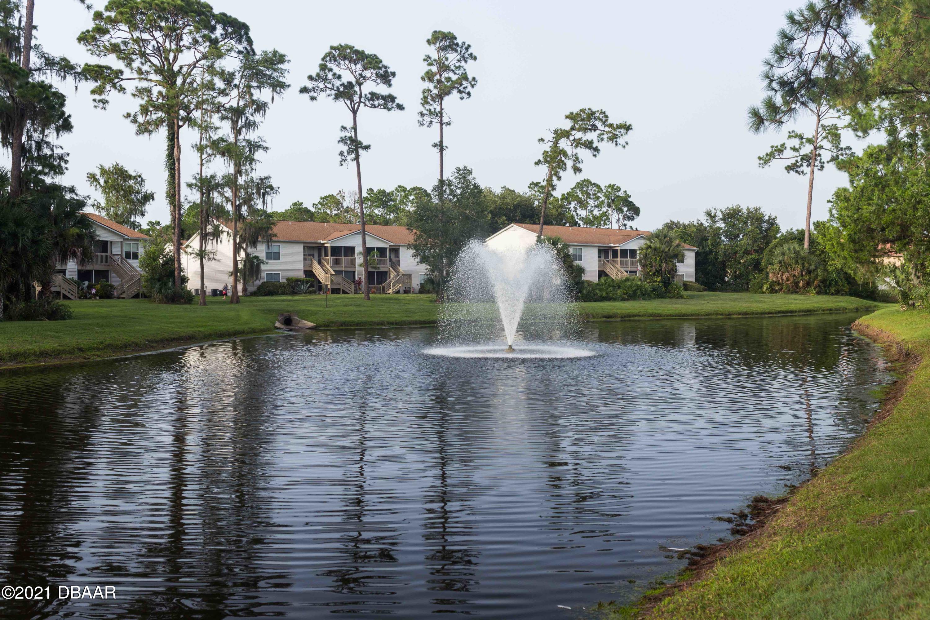 1600 Big Tree Road, Unit B8 South Daytona, FL 32119 - Photo 7 of 27 a view of a lake with a house in the background