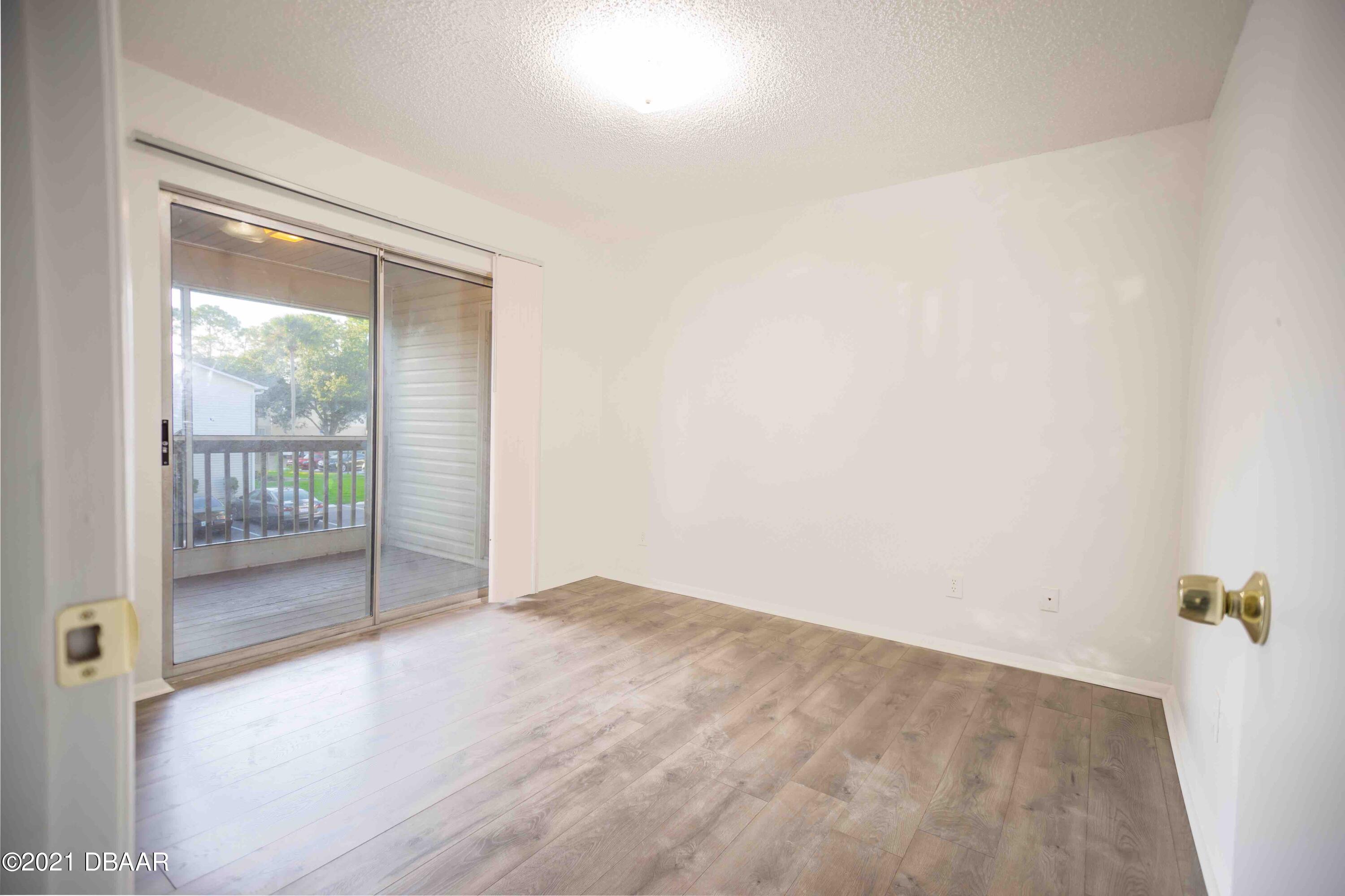 1600 Big Tree Road, Unit B8 South Daytona, FL 32119 - Photo 10 of 27 a view of a room with wooden floor and a window