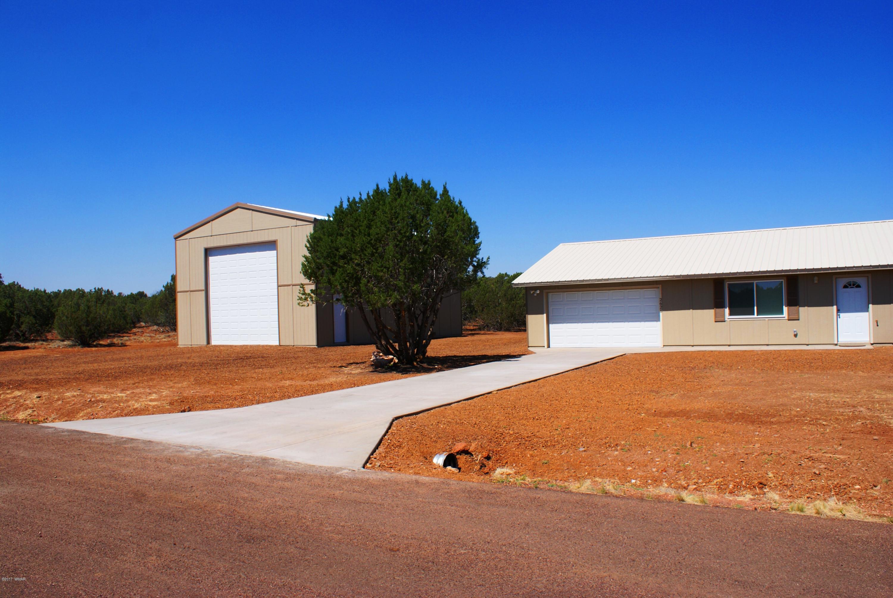 2628 Elk Run Loop Show Low, AZ 85901 - Photo 1 of 26 a backyard of a house with yard and garage