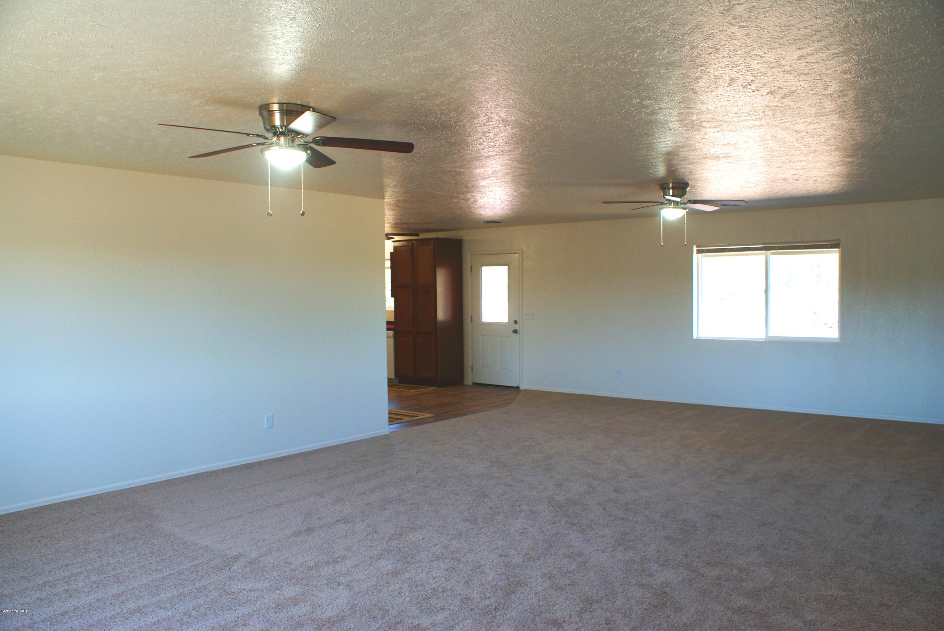 2628 Elk Run Loop Show Low, AZ 85901 - Photo 3 of 26 an empty room with windows and fan