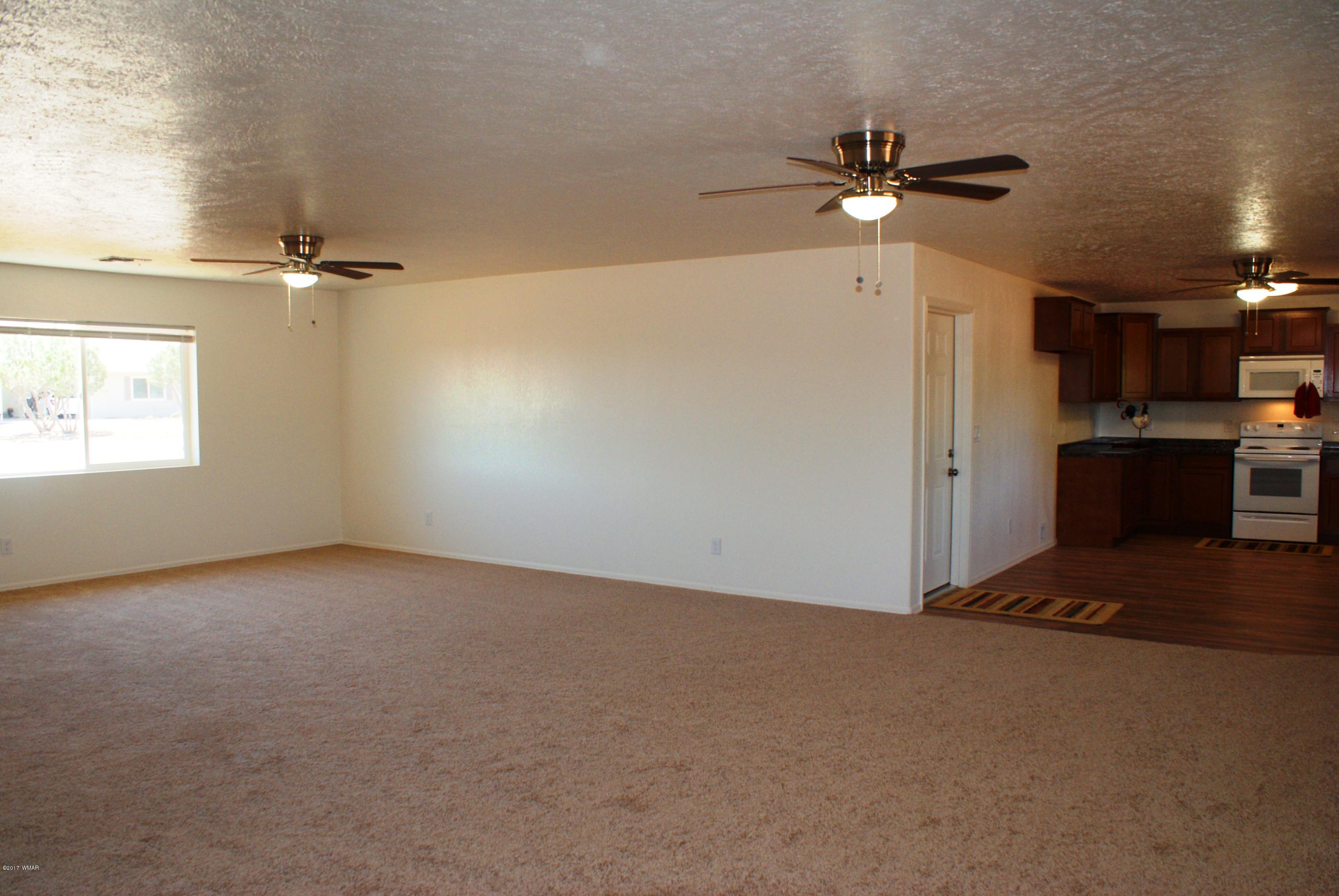 2628 Elk Run Loop Show Low, AZ 85901 - Photo 4 of 26 a view of a livingroom with a ceiling fan and window