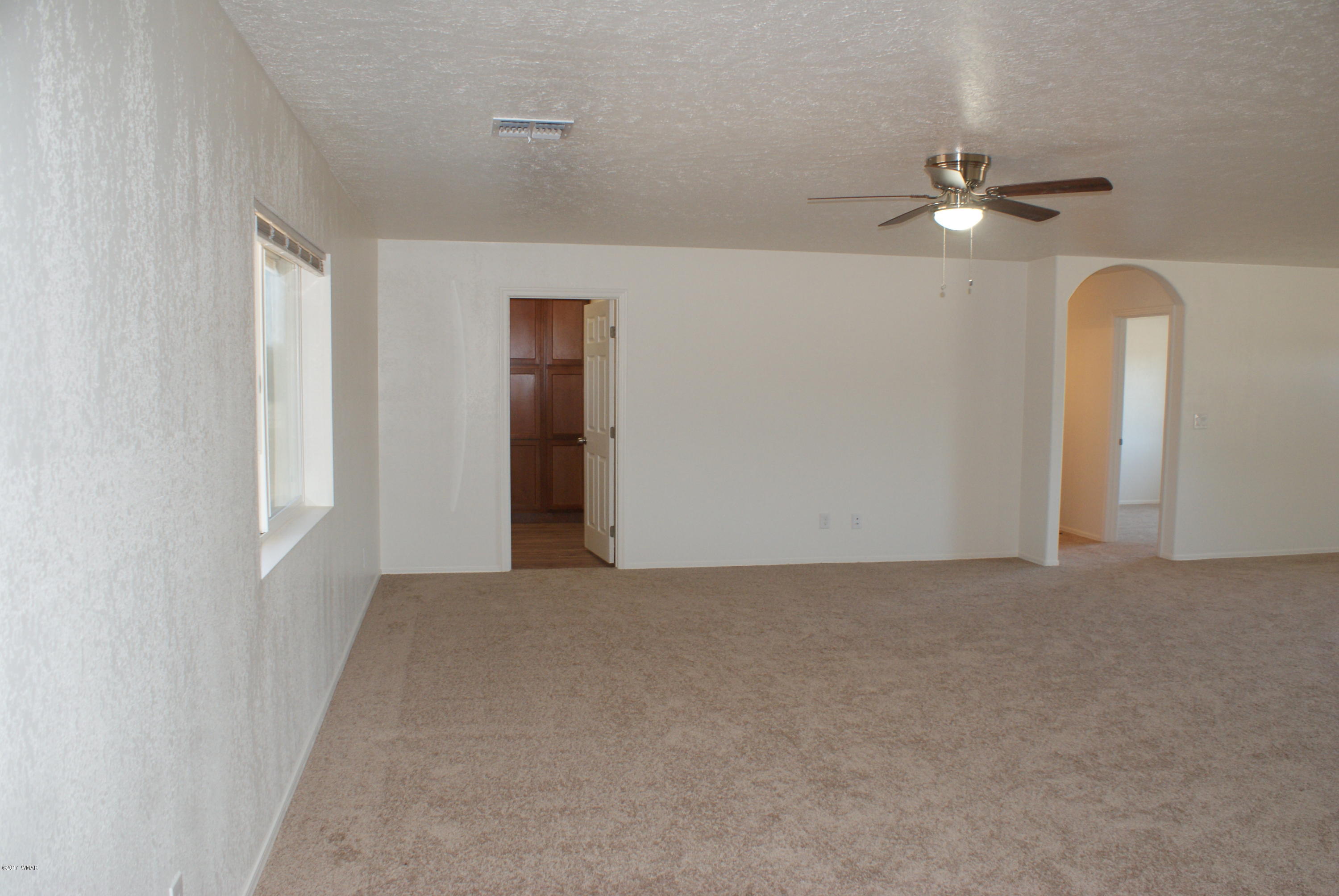 2628 Elk Run Loop Show Low, AZ 85901 - Photo 5 of 26 a view of a livingroom with a ceiling fan and window