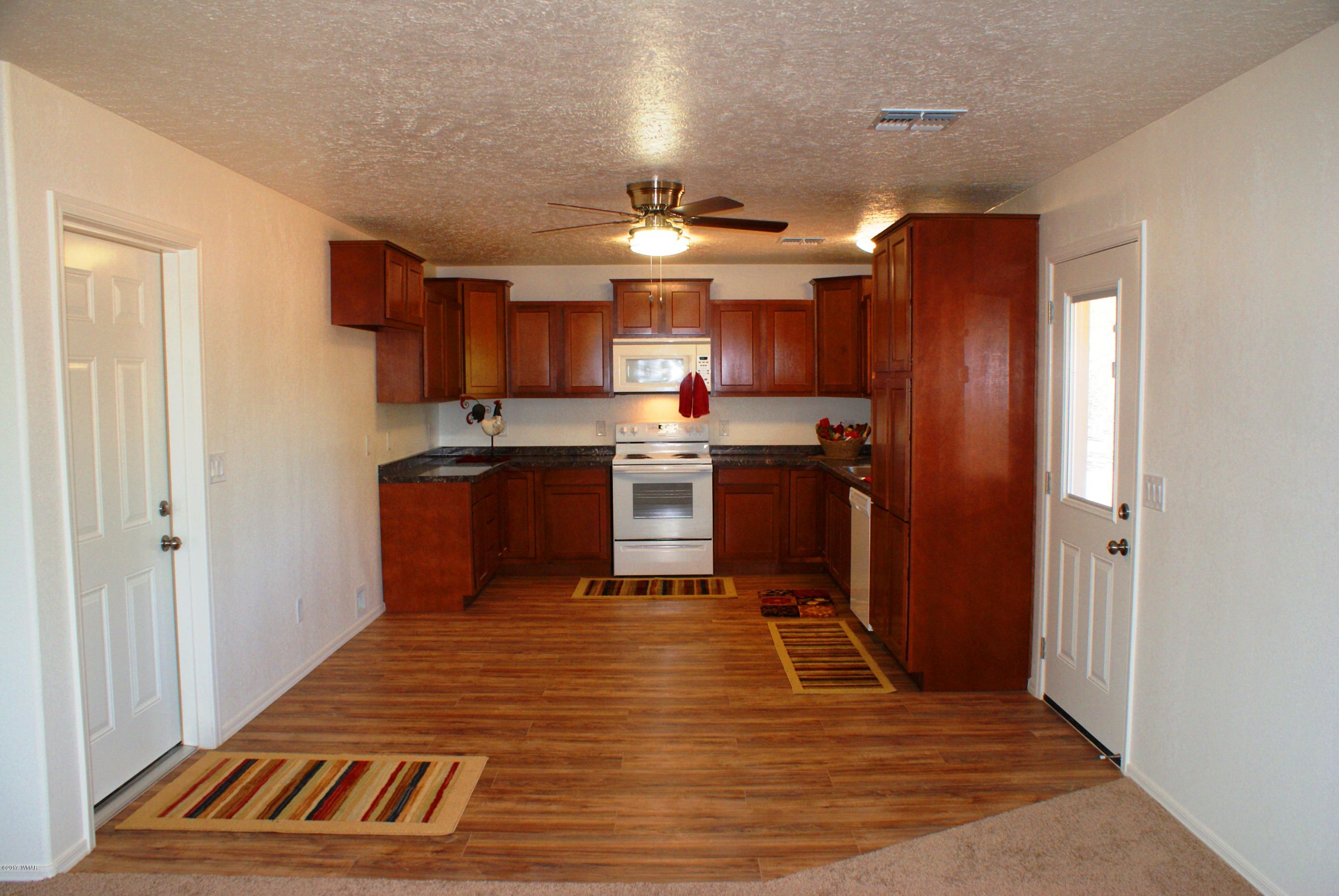 2628 Elk Run Loop Show Low, AZ 85901 - Photo 6 of 26 a kitchen with stainless steel appliances granite countertop a sink refrigerator and cabinets