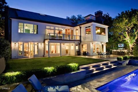 a view of a house with a yard patio and fire pit