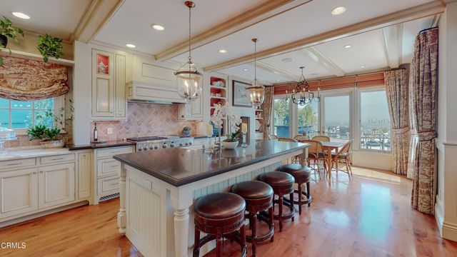 a view of a dining room with furniture a chandelier and wooden floor