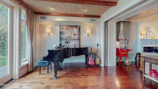 a balcony with wooden floor and trees in the background