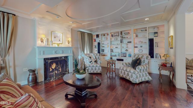 a large bathroom with a double vanity sink a large mirror and a bathtub next to a window