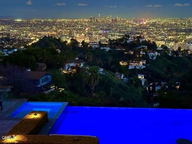 an aerial view of a house with swimming pool having outdoor seating